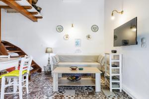 a living room with a couch and a table at Pyrgos Country House in Skopelos Town