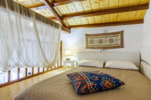 a bedroom with a large bed and wooden ceilings at Pyrgos Country House in Skopelos Town