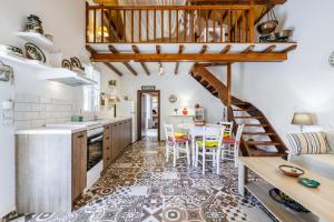 a kitchen with a staircase and a table and chairs at Pyrgos Country House in Skopelos Town
