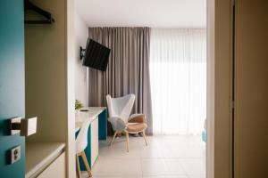 a room with a desk and a chair and a window at Hotel Cicò in Torre Santa Sabina