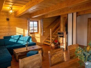 a living room with a blue couch and a table at Chata Sipkova II in Terchová +27 photos