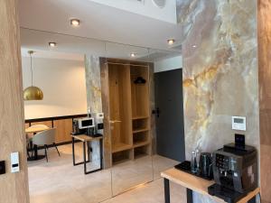 a room with a glass wall with a coffee maker on a table at Apartament - VIDOK 110 in Olsztyn