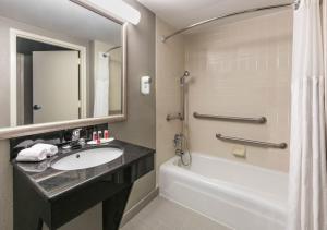 a bathroom with a sink and a tub and a shower at Boutique Hotel in Texarkana +33 photos