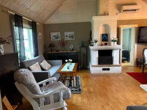a living room with a couch and a fireplace at Kapelludden Östra Öland in Köpingsvik