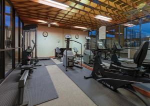 a gym with treadmills and ellipticals in a room at Boutique Hotel in Texarkana