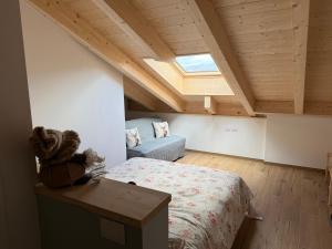 a bedroom with a bed and a table and a window at Dalla zia Gemma in Carano