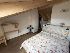 a bedroom with a bed and a wooden floor at Dalla zia Gemma in Carano