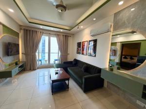 a living room with a couch and a table at Designer One Bedroom Apartment With Balcony & Mountain Views Opposite Centaurus Mall ISB in Islamabad +72 photos