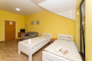 a room with two beds and a couch and a chair at Vikendica Donji Humac in Donji Humac +25 photos