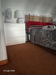 a bedroom with a bed and a dresser at Mivida Casa vacanze in Turin