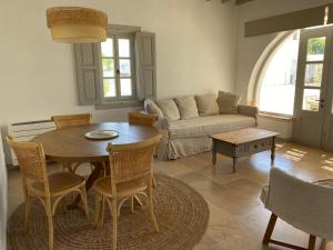 a living room with a table and a couch at Villa Palmosa in Skala
