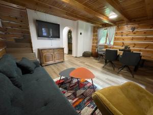 a living room with a couch and a table at Chata Harmony in Ružomberok