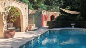 a swimming pool in front of a house at Le Moulin des Salces in Saint-Privat