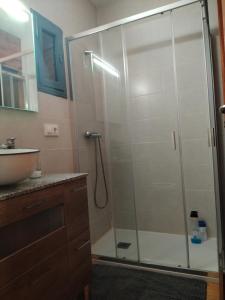 a shower stall in a bathroom with a sink at Casa de las Ascuas in Ourense +33 photos