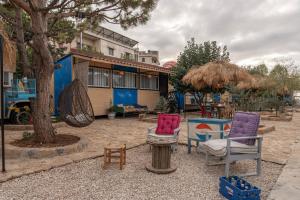 a group of chairs sitting in front of a house at Maison Jwar - Charming Caravan Experience - Unique Summer Getaway in Jiwār al Ḩawz