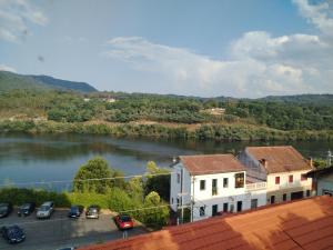a view of a river with cars parked next to a building at Casa de las Ascuas in Ourense