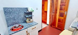 a kitchen with a counter with a red bowl on it at Dans place in Moshi