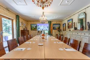a conference room with a large wooden table and chairs at Logis Hôtel La Bastide De Grignan & Restaurant La Chênaie in Grignan +119 photos