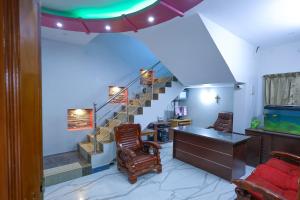 a living room with a staircase and a desk at Mount Zion Holidays in Kuttālam