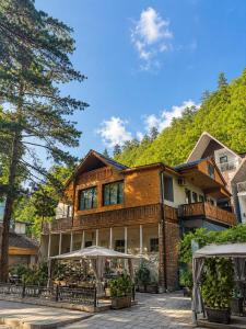 a large house with trees in front of it at Greenwood in Borjomi