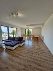 a large living room with a couch and a table at Pokoje u Emilii in Mikołajki