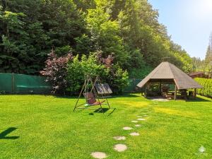 a yard with a swing and a gazebo at Chata Sipkova I in Terchová +28 photos
