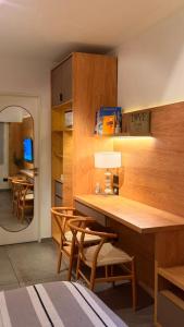a kitchen with a table and chairs and a dining room at Oh Barrancas in Buenos Aires