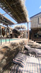 two beds on a patio in a building at הבית החום בערבה in Sappir