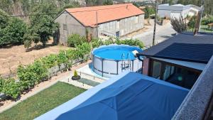 an overhead view of a house with a swimming pool at Casa Rosàlia in Castro Daire