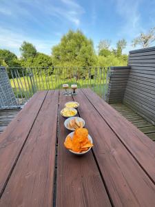 a wooden table with three bowls of food on it at Gezellige familie Gîte Han & Dinant 9p in Rochefort