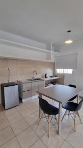 a kitchen with a table and two chairs and a table at Los Olivos in San Luis