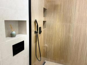 a shower with a glass door in a bathroom at Leśny Azyl Rzeszów in Hermanowa +21 photos