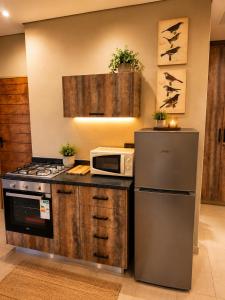 a kitchen with a stove and a microwave at Lloyds - 6 in Ermelo