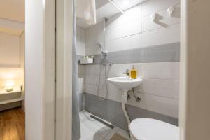 a bathroom with a toilet and a sink at Poli in Šmarje-Sap +8 photos