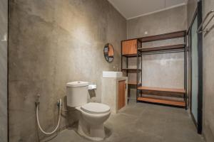 a bathroom with a toilet and a shower at Villa Dake Tanah Lot in Tanah Lot