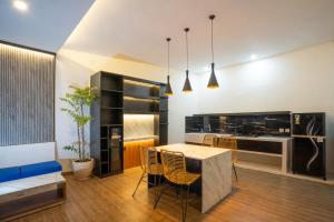 a kitchen and dining room with a table and chairs at Villa Dake Tanah Lot in Tanah Lot