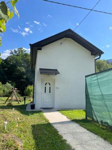 a small white building with a door on the side at Apartman Elma in Jajce