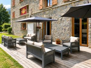 a group of chairs and umbrellas on a deck at Hôtel Le Chastellan in Valberg