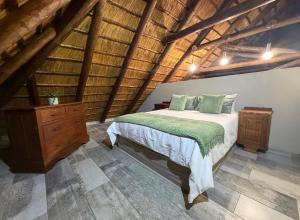 a bedroom with a bed and a wooden dresser at La Bella Vita Marloth Park in Marloth Park +30 photos