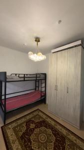 a room with two bunk beds and a chandelier at Радуга in Chon-Sary-Oy