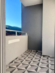 a room with a black and white tiled floor at Apartman ART Foca in Foča