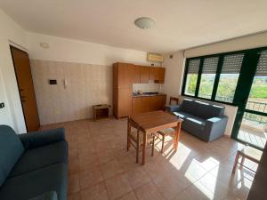 a living room with a couch and a table at Polena Residence Hotel in Marina di Montenero