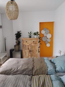 a bedroom with a bed and a wooden cabinet at Apartmán pod hradom B in Trenčín +11 photos