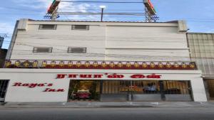 a building with a sign on the front of it at Raya's Inn in Kumbakonam