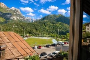 a view from a window of a parking lot with mountains at La Dimora del Cadore in Domegge di Cadore
