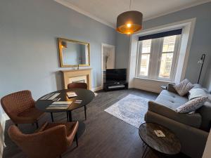 a living room with a couch and a table at Dunes Apartment Troon in Troon