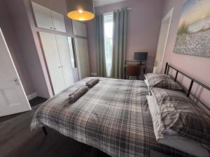 a bedroom with a bed with two pillows on it at Dunes Apartment Troon in Troon