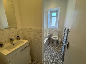a bathroom with a sink and a toilet at Dunes Apartment Troon in Troon +3 photos