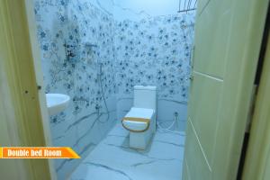 a bathroom with a toilet and a sink at Mount Zion Holidays in Kuttālam +42 photos