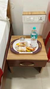 a tray of food and a bottle of water on a table at Raya's Inn in Kumbakonam